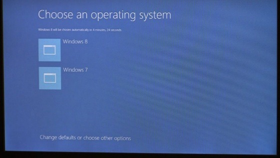 Dual boot options screen in Windows 8: Choose an operating system Icon 1: Windows 8; icon 2: Windows 7; Link to Change defaults or choose other options