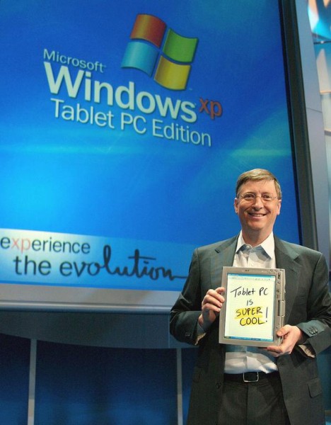 About three weeks after XP's launch, Gates unveiled Windows XP Tablet PC Edition during Comdex 2001. The first Tablet PCs debuted about a year later. Here Gates holds one during the November 2002 launch event. [Microsoft]